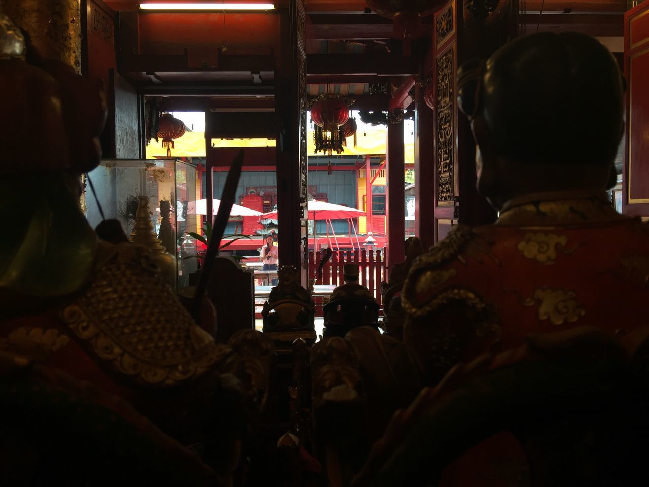 REAR VIEW OF PEOPLE IN CORRIDOR OF TEMPLE