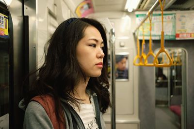 Portrait of beautiful young woman in train