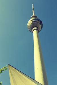 Low angle view of communications tower against sky