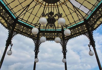 Low angle view of chandelier hanging on ceiling of building