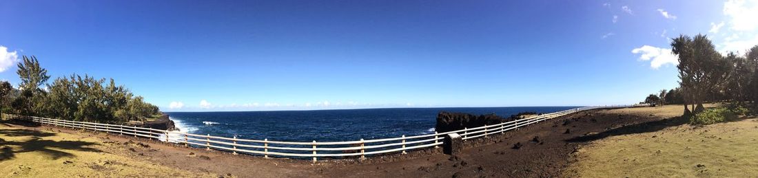 Scenic view of beach against clear blue sky