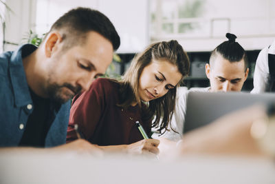 Creative business professionals working at table in office