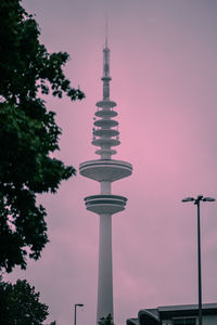 Low angle view of communications tower against sky