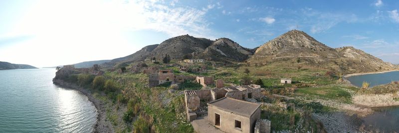 Panoramic view of sea and buildings against sky