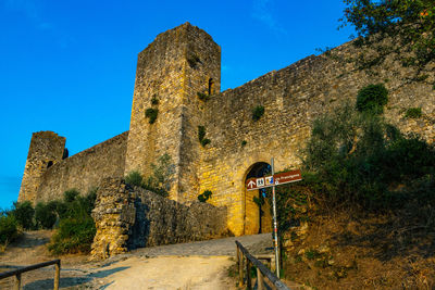 Low angle view of fort against blue sky