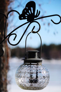 Close-up of electric lamp hanging on metal