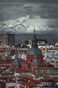 Aerial view of illuminated buildings in city against sky