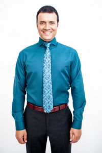 Portrait of a smiling man standing against white background