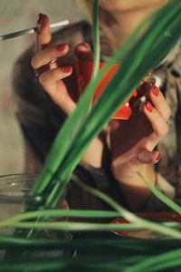 Close-up portrait of woman holding camera