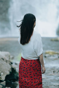 Side view of woman standing at beach