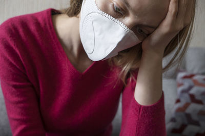 Midsection of young woman wearing hat