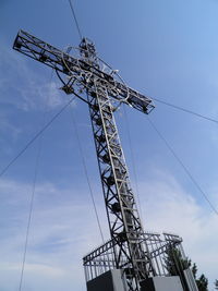 Low angle view of crane against sky