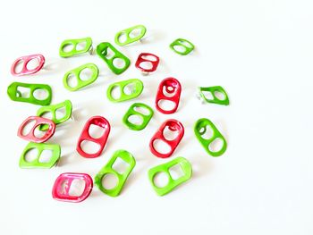 High angle view of multi colored candies against white background