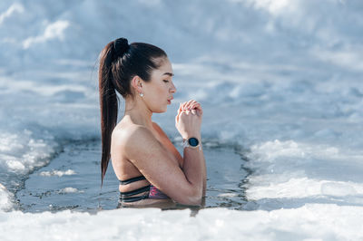 Portrait of young woman swimming in pool