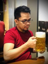 Young man drinking glasses in restaurant