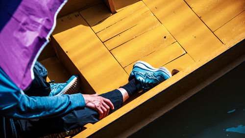 Low section of man sitting on roof