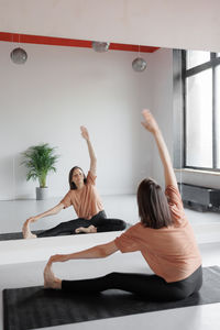 Full length of woman exercising in gym