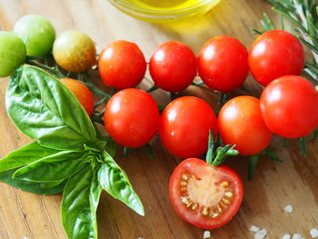 Close-up of tomatoes with basil leaves on table