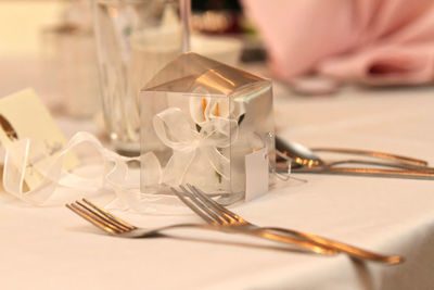 Close-up of ribbon and plastic box on table