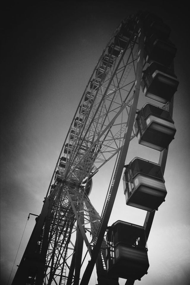 low angle view, built structure, architecture, metal, sky, clear sky, amusement park ride, ferris wheel, arts culture and entertainment, engineering, metallic, silhouette, amusement park, dusk, connection, outdoors, no people, day, transportation, tall - high
