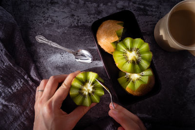 High angle view of hand holding apple