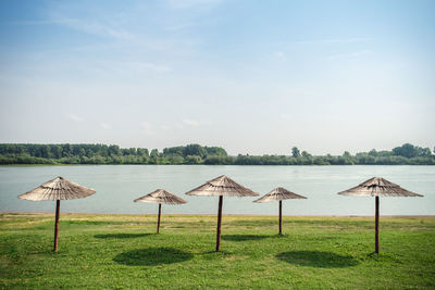 Bamboo sunshade on the field in front of a river