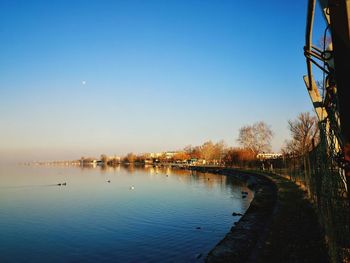 Scenic view of river against clear blue sky