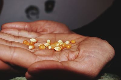 Cropped hands of person corns