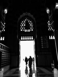 Rear view of people walking in temple