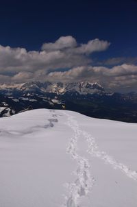 Scenic view of snow covered mountains against sky