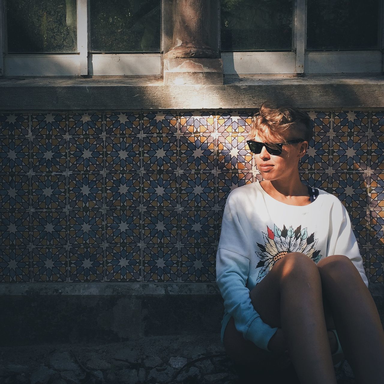 low section, pets, domestic animals, person, lifestyles, standing, mammal, one animal, leisure activity, animal themes, men, sitting, dog, sunlight, day, part of