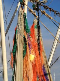 Low angle view of clothes drying on rope against sky