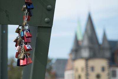 Close-up of padlocks on chain against sky