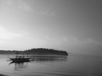 Boat sailing in sea against sky