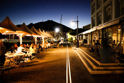 Illuminated city street at night