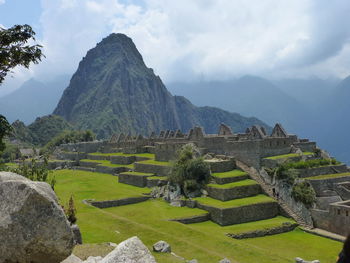 Scenic view of mountains against cloudy sky