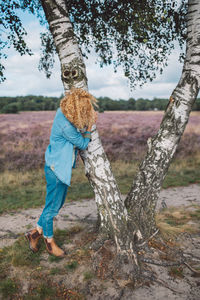 Rear view of woman standing on field