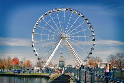 Ferris wheel at amusement park against sky