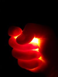 Close-up of hand holding illuminated lamp