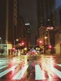 Illuminated city street at night