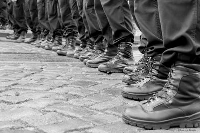 Low section of police force standing in row on walkway