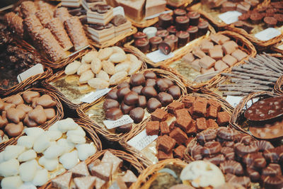 Full frame shot of chocolates in containers at store