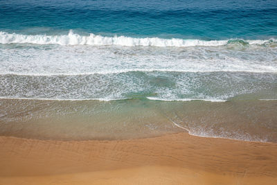 High angle view of surf on beach