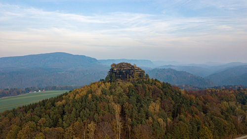 Scenic view of mountain against cloudy sky