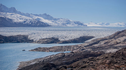 Scenic view of sea and mountains against sky