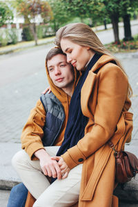 Happy couple sitting in park