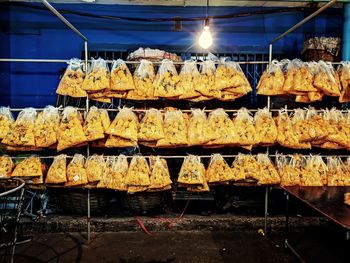 Food in plastic bags hanging on pipes