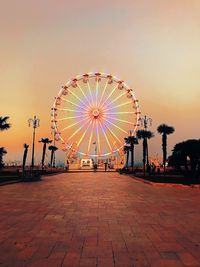 Ferris wheel in city at sunset