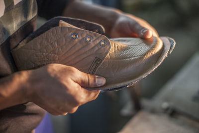 Shoemaker working on shoe in workshop