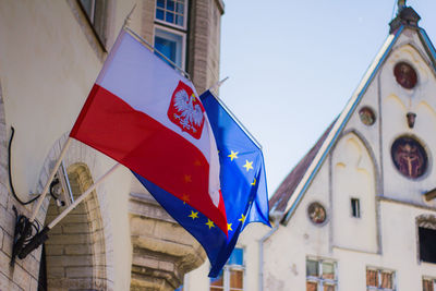 Low angle view of flag against buildings